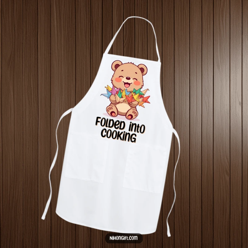 Funny apron with a joyful bear cub holding a stack of colorful origami cranes, perfect for a whimsical kitchen.