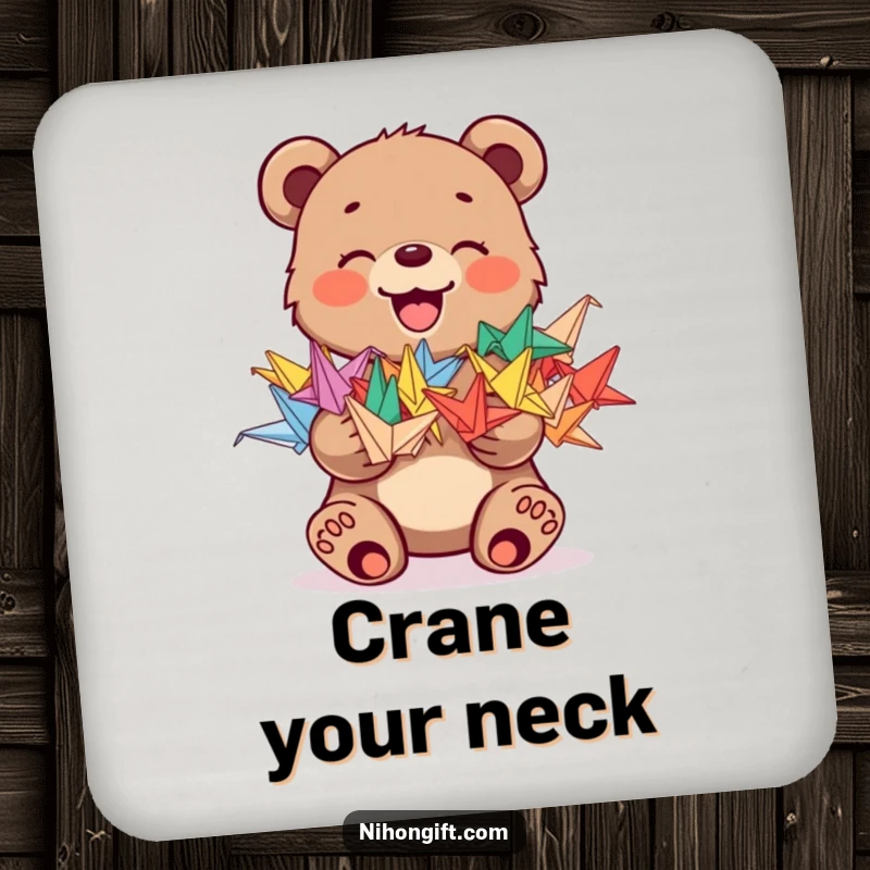 Funny drink coaster with a joyful bear cub holding a stack of colorful origami cranes, adding humor to tables.