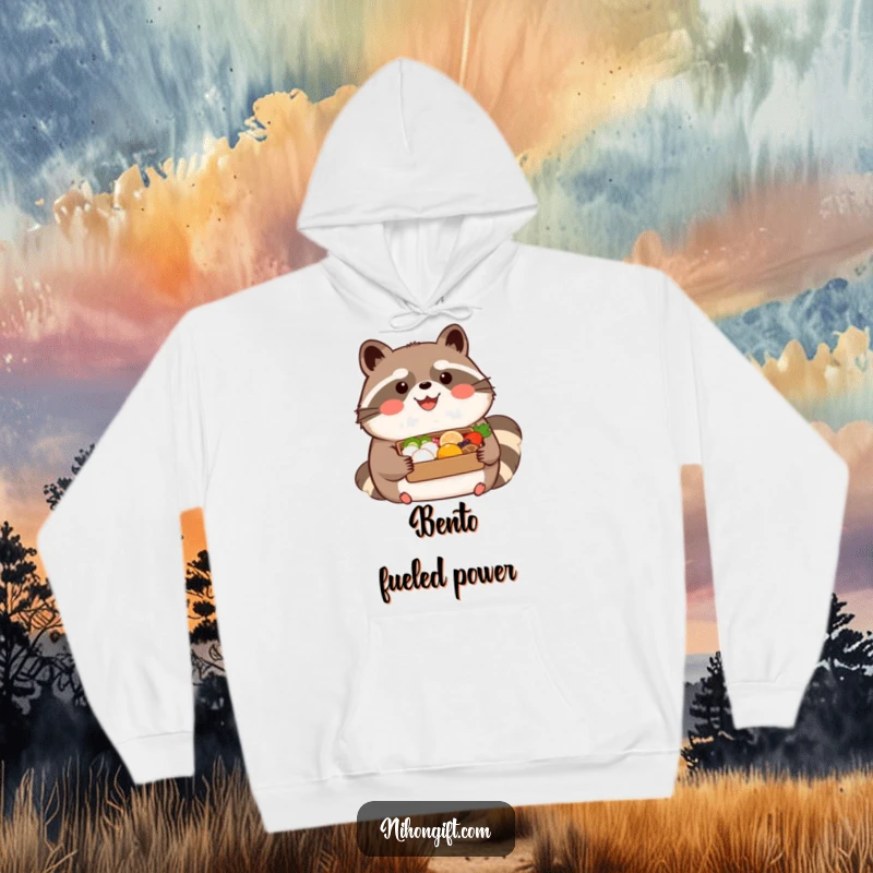 Funny kawaii tanuki wearing a happy expression, holding a beautifully presented bento on a hoodie, ideal for cozy culinary fun.