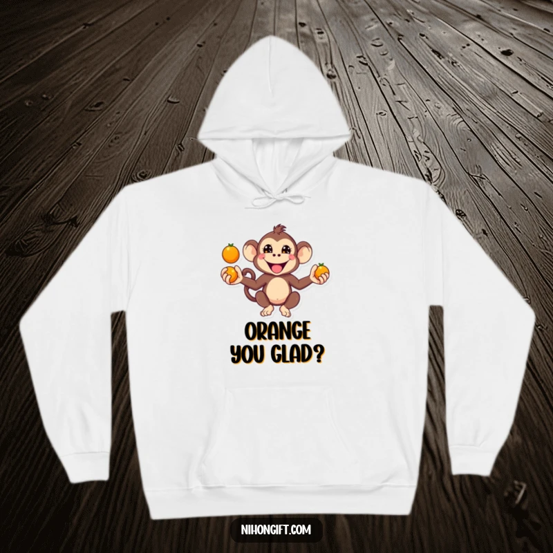 Funny Kawaii Monkey Hoodie depicting a monkey juggling oranges with a mischievous grin.