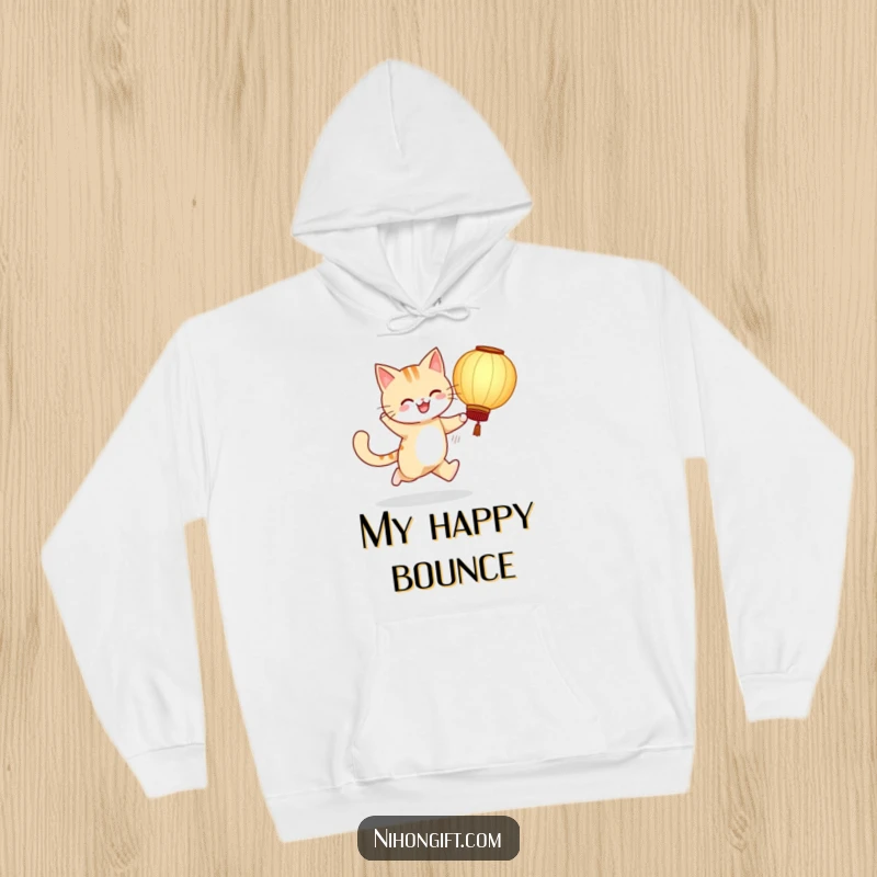 Funny hoodie depicting a cheerful cat skipping with a large paper lantern, offering comfort and humor.