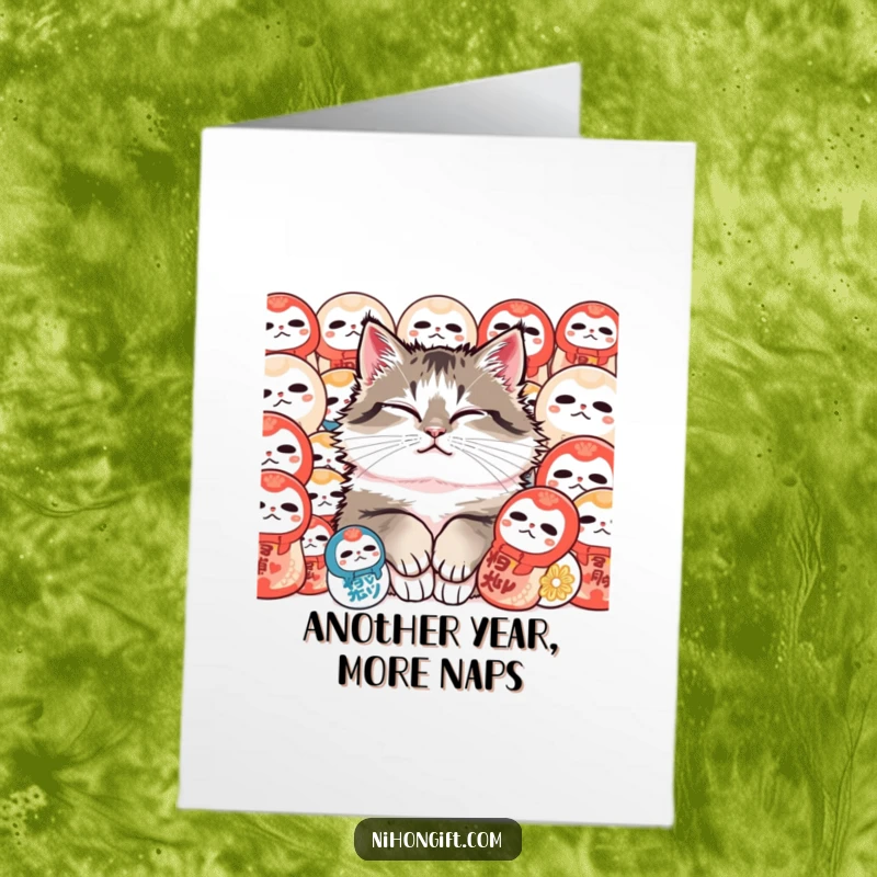 Funny Free Printable Birthday Card: Content fluffy cat purrs peacefully nestled amongst colorful, traditional Daruma dolls, celebrating a special day.