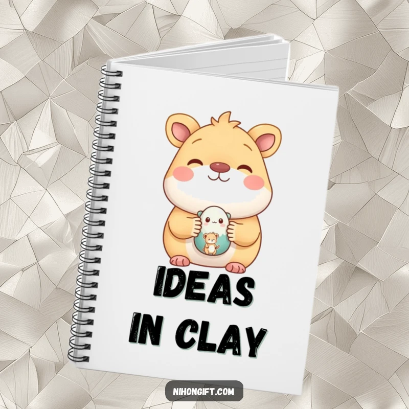 Funny notebook featuring a happy animal proudly displaying a small, painted ceramic figure, perfect for jotting down creative ideas.
