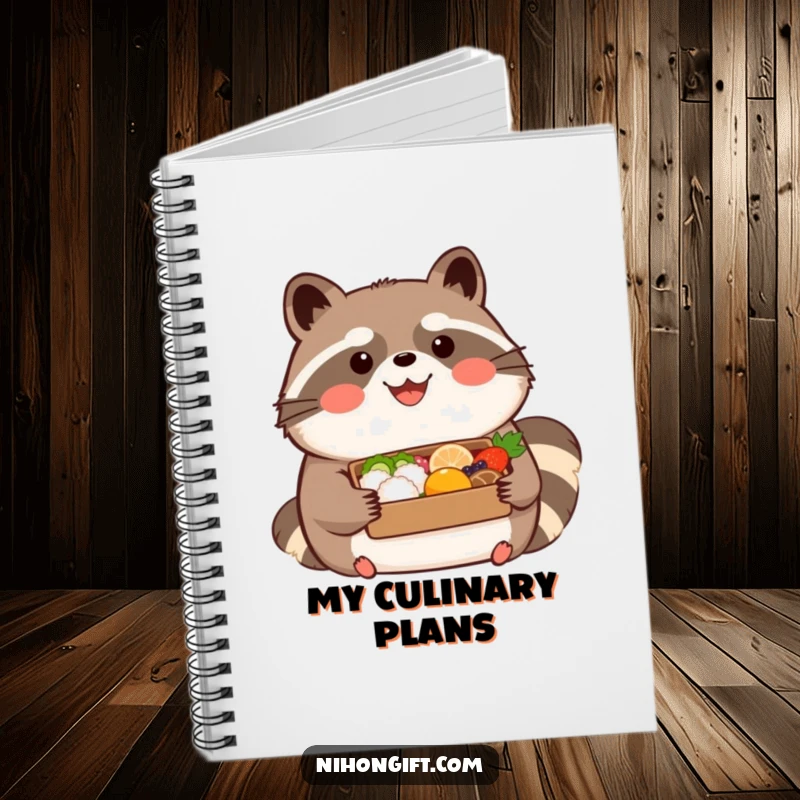 Funny kawaii tanuki wearing a happy expression, holding a beautifully presented bento on a notebook, great for notes and gifts.
