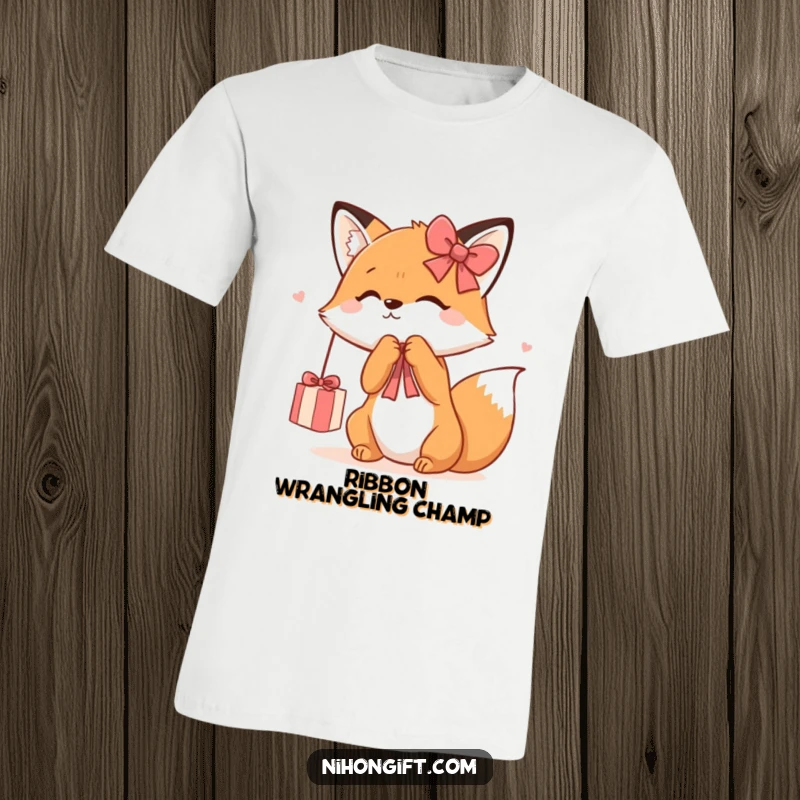 Funny Kawaii Fox T-Shirt showing a cute fox playfully batting at a dangling gift ribbon, full of childlike wonder and joy.