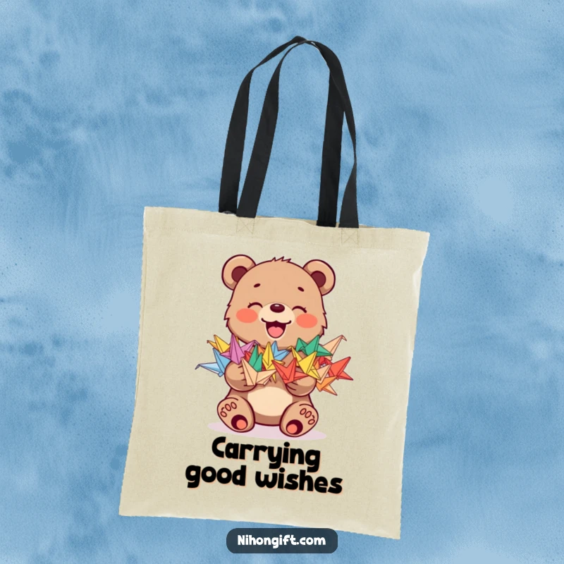 Funny tote bag with a joyful bear cub holding a stack of colorful origami cranes, great for shopping.